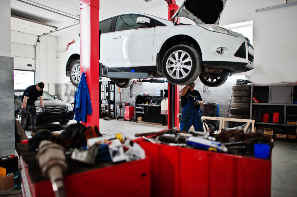 Car service centre showing workers doing the car work.